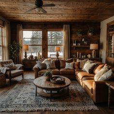 a living room filled with lots of furniture next to a window covered in wood planks