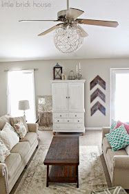 a living room filled with furniture and a ceiling fan