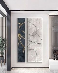 two paintings are hanging on the wall next to each other in a modern living room