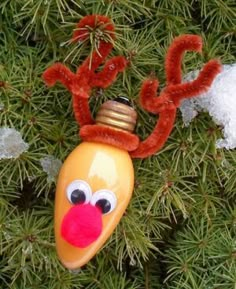 a christmas ornament hanging from a tree with reindeer nose and antlers on it