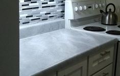 a stove top oven sitting inside of a kitchen next to a sink and countertop