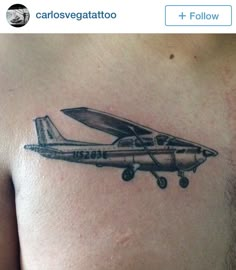 a small airplane tattoo on the chest