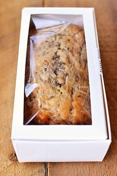 a close up of a muffin in a box on a table