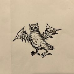 a drawing of an owl sitting on top of a piece of paper