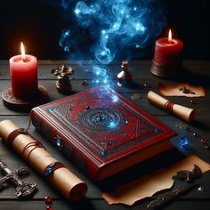 a red book surrounded by candles and other items on a wooden table in front of it