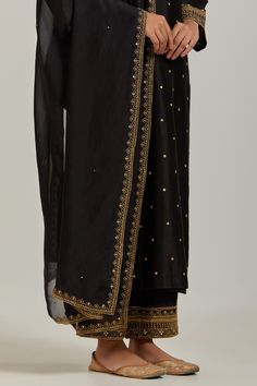 Black chanderi silk kurta with sequin, floral embroidery and V neckline. Paired with pant and dupatta.
Component: 3
Pattern: Embroidery
Type Of Work: Floral, sequin
Neckline: V neck
Sleeve Type: Long sleeves
Fabric: Chanderi Silk
Color: Black
Other Details: 
Embroidered sheer dupatta
Occasion: Sangeet - Aza Fashions V Neck Kurta, Sheer Dupatta, Silk Kurta Set, Kurta Set For Women, Silk Kurta, Embroidery Floral, Pattern Embroidery, Silk Embroidery, Kurta Set