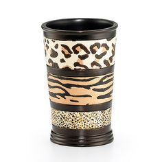 a black and white cup with leopard print on the sides, sitting in front of a white background