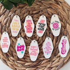 six keychains with different designs on them are sitting in a wicker basket