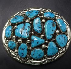 ORVILLE TSINNIE NAVAJO BELT BUCKLE DESCRIPTION: 14 perfect specimens of high blue Kingman turquoise set in heavy gauge sterling silver. This new old stock belt buckle will be a cherished addition to your collection of fine Native American jewelry. MEASUREMENTS:  Buckle measures 3 3/8" x 2 3/4" Buckle will accommodate a 1 1/2" wide strap WEIGHT:  109.5 grams SIGNED: Orville Tsinnie (Navajo) STERLING:  yes, stamped STERLING Navajo Belt, Turquoise Belt Buckle, Concho Belts, Jewelry Measurements, Turquoise Belt, Concho Belt, Jewelry Picture, Kingman Turquoise, Suspender Belt