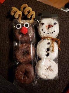 two donuts in plastic bags with reindeer noses and nose decorations on them, one is chocolate doughnuts and the other has pretzels wrapped in cellophane