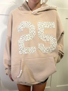 a woman wearing a leopard print hoodie with the number 35 printed on it