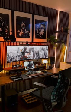 a computer desk with a laptop on top of it next to a monitor and keyboard