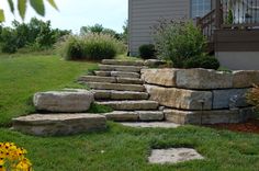 stone steps leading up to a house in the grass