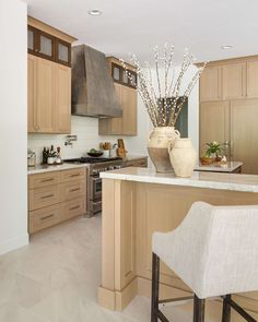 a large kitchen with wooden cabinets and white counter tops