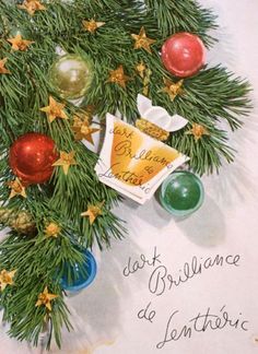 an old christmas card with ornaments hanging from it's sides and the words, just brilliante de l'entourievre