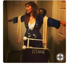 a woman dressed as a pirate with her arms outstretched in front of the door,