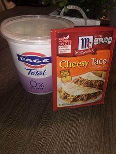 cheesey taco next to a cup of yogurt