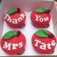 four red cupcakes with green leaves and thank you written on them in a box