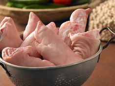 several pieces of raw chicken in a colander