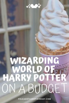 a hand holding an ice cream cone with the words wizard world of harry potter on it