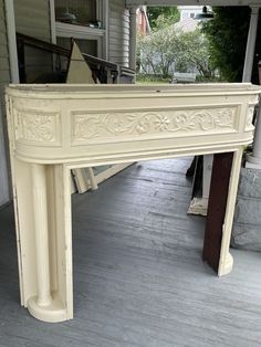 an old white painted table on the porch