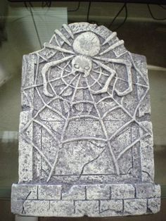 a stone sculpture with a spider on it