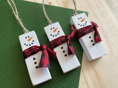 These little guys are so adorable, you won't be able to resist them! Celebrate the season with these charming snowman ornaments that are perfect for hanging on your tree, wreaths, gifts, or anywhere you want to spread some holiday cheer! This listing is for a set of 3 Wooden Snowman Ornaments. Each ornament is made to order from high-quality pine and measures approximately 1" w x 3" h x 0.6" deep. The wood is painted with chalk paint, lightly sanded around the edges for a rustic look, and finished with a screw eye and ribbon for hanging. Twine is also added at the top for easy display, though the twine is left untied so you can adjust the height to fit any size tree, wreath, or decoration. Jenga Christmas Ornaments Diy, Jenga Ornaments, Clothespin Ornaments, Rustic Snowman, Tree Wreaths, Ornaments Wood, Snow Men, December Crafts