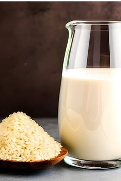 a wooden spoon next to a glass and bottle of milk