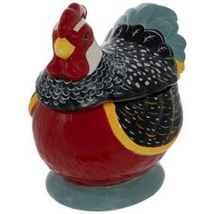 a ceramic rooster figurine sitting on top of a table