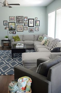 a living room filled with furniture and pictures on the wall