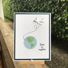 a card with an airplane flying over the earth