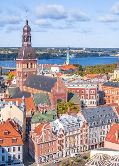 an aerial view of the city with many buildings and water in the backround