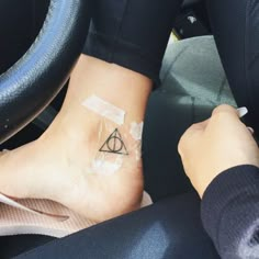 someone with a harry potter tattoo on their foot