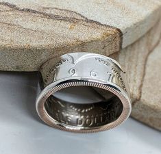 a silver ring sitting on top of a stone slab