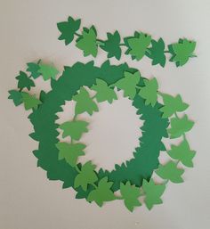 green paper leaves arranged in the shape of a wreath