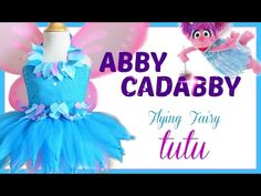 a blue and pink fairy dress with the words aby cadabby on it