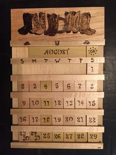 a wooden calendar with boots and numbers on it