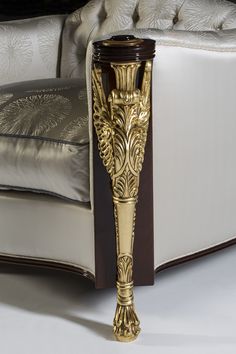 a golden vase sitting on top of a white couch