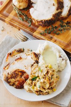 a white plate topped with chicken and mashed potatoes