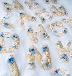 the letters and numbers are made out of glass beads, with blue flowers on them