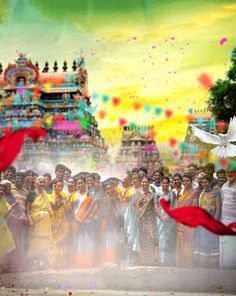 a large group of people standing in front of a colorfully painted building and flying kites