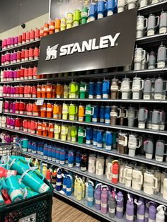 a display in a store filled with lots of different colored bottles and containers on shelves