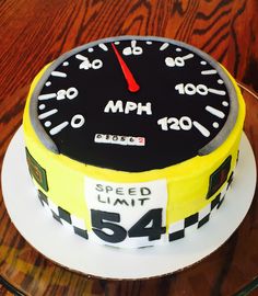 a speedometer cake on a plate with the words speed limit 544 written on it