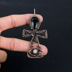 Handmade Copper Chain Size 18-20Inch - https://www.etsy.com/in-en/listing/1162990726 Welcome to our little shop, where you can find handmade copper wire jewelry and more, for you and your loved ones. We do accept custom orders also, kindly message us for more. Ankh Pendant Obsidian Eye Pendant Copper Wire Wrapped Pendant Hieroglyphic Symbol Ankh Necklace Cross Pendant with Gemstone Eye of Horus Gemstone : Obsidian Eye Pendant length : 9 CM Metal : Copper  * Protection:- Copper will be tarnished after a while so try to limit contact with lotions, soaps or anything moist and never wear it in the shower, swimming or anywhere else it may come in contact with water. If tarnish becomes an issue, you may clean this item with jewelry cleaning cloth or ultra polishing pads. * Packing:- Your jewelry Ankh Wire Wrap, Bronze Ankh Shaped Metal Jewelry, Bronze Ankh Metal Jewelry, Spiritual Ankh Shaped Metal Jewelry, Bronze Ankh Necklace, Unique Ankh-shaped Brass Jewelry, Unique Ankh Shaped Brass Jewelry, Handmade Ankh Spiritual Jewelry, Copper Cross Jewelry For Gifts