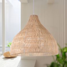 a light that is hanging from a ceiling in a room with white walls and windows