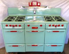 an old fashioned blue stove with red knobs