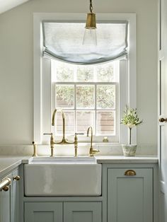 a kitchen sink under a window in front of a window