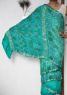 Discover the timeless elegance of our Gaji Silk Saree, a true masterpiece of traditional craftsmanship. Handcrafted from luxurious Gaji silk, this saree offers a lustrous sheen and a smooth, soft texture that drapes beautifully. The intricate patterns and vibrant colours are the result of meticulous hand-dyeing techniques, making each saree a unique piece of art. Perfect for special occasions, weddings, or festive celebrations, our Gaji Silk Saree combines heritage and sophistication.  ➢ Manufac Bohemian Green Pre-draped Saree With Dupatta, Bollywood Style Green Pre-draped Saree With Motifs, Green Bohemian Pre-draped Saree For Wedding, Bohemian Green Art Silk Traditional Wear, Green Bohemian Art Silk Traditional Wear, Festive Green Bohemian Saree, Festive Turquoise Saree In Traditional Drape, Festive Turquoise Saree With Traditional Drape, Green Bohemian Silk Saree