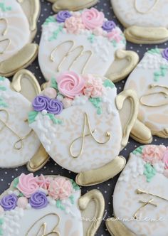 decorated cookies are arranged in the shape of tea cups and kettles with flowers on them