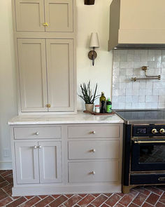 a kitchen with an oven and cabinets in it